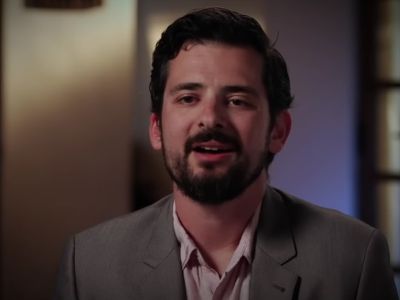 Dominic Steavu is in a suit sitting down to talk.